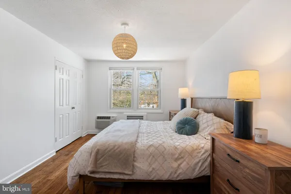 a bedroom with a bed and a lamp