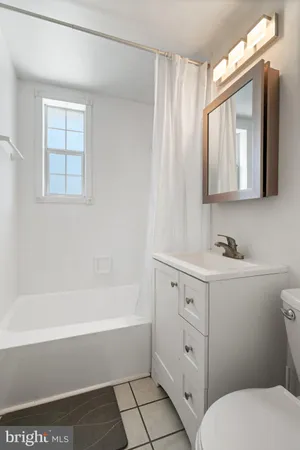 a bathroom with a sink a toilet and a bathtub