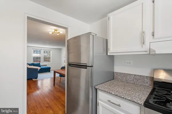 a kitchen with a refrigerator and a stove top oven