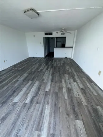 a view of a room with wooden floor