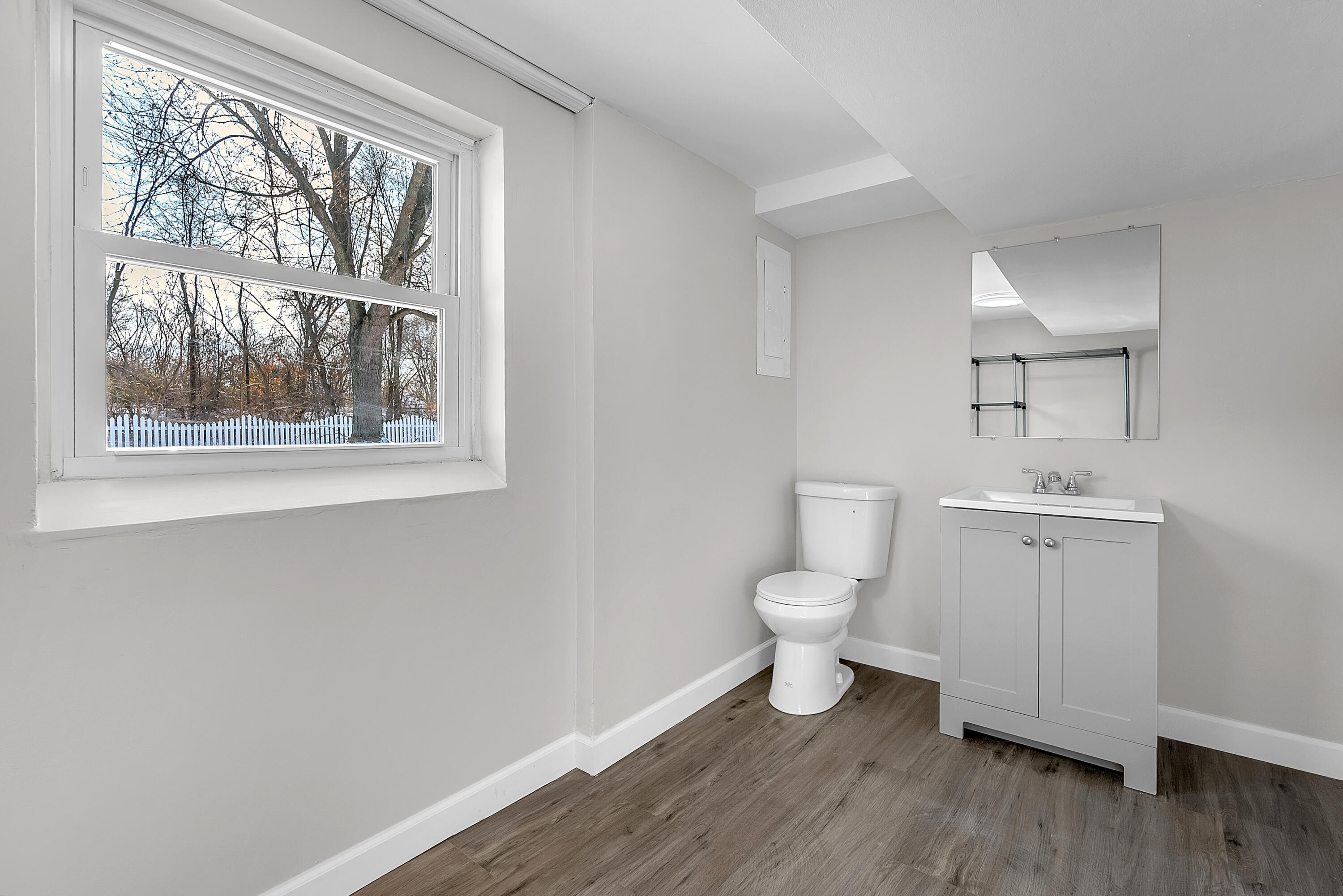 6395 Valleyview Avenue Portage, IN 46368 - Photo 17 of 20 a bathroom with a toilet a sink and a window