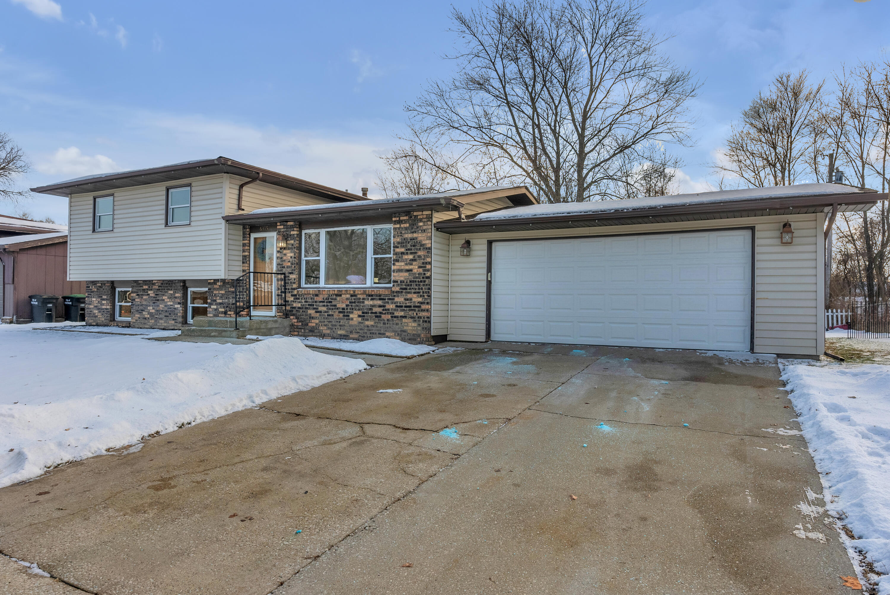 6395 Valleyview Avenue Portage, IN 46368 - Photo 2 of 20 a front view of a house with a yard and garage