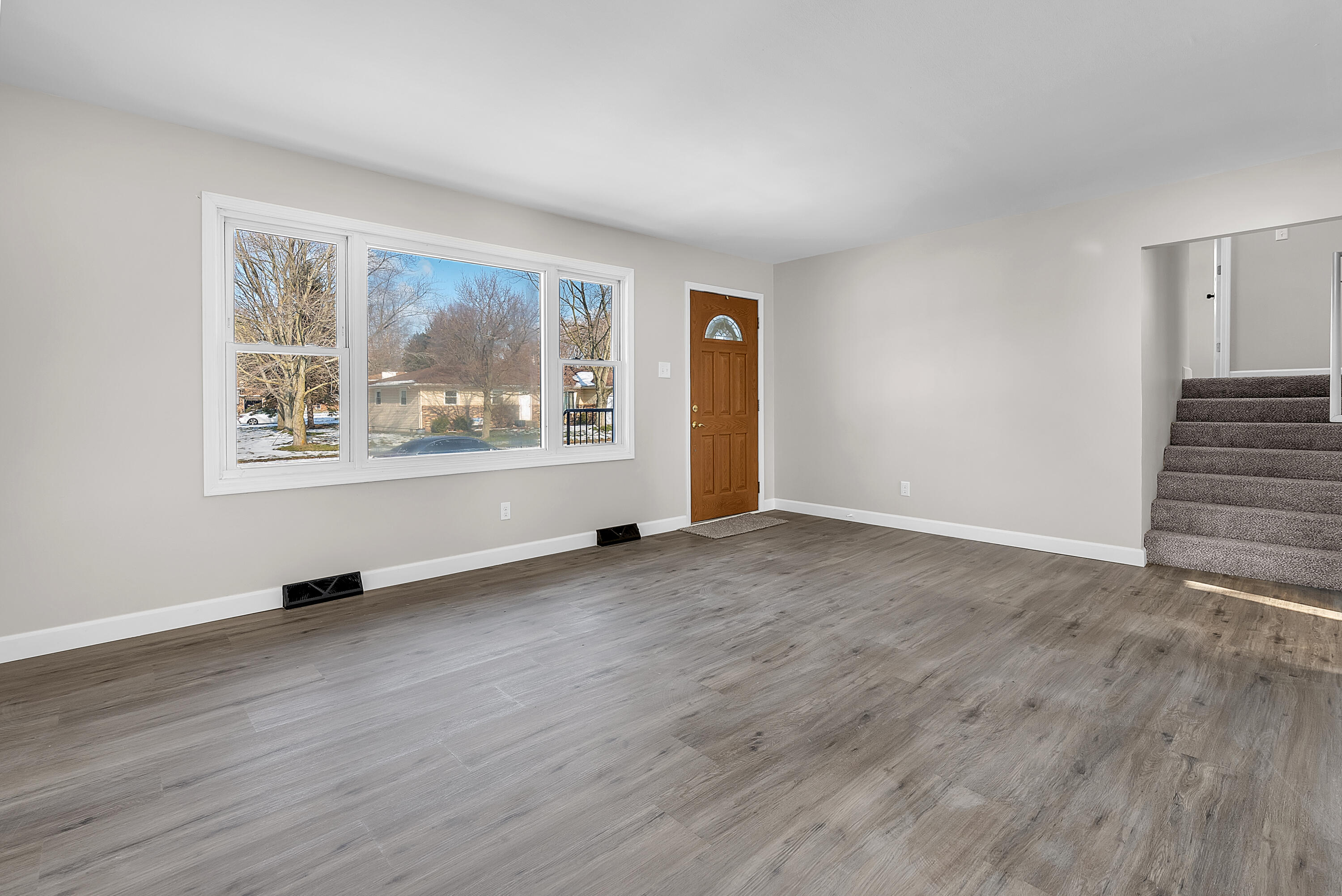 6395 Valleyview Avenue Portage, IN 46368 - Photo 4 of 20 a view of an empty room with wooden floor and a window