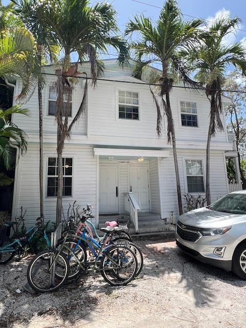 2 Nassau Lane, Unit 2 Key West, FL 33040 - Photo 2 of 12 a view of a patio with couple of cars parked in front of a house