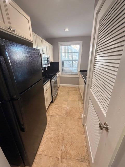2 Nassau Lane, Unit 2 Key West, FL 33040 - Photo 7 of 12 a kitchen with granite countertop a refrigerator and a sink