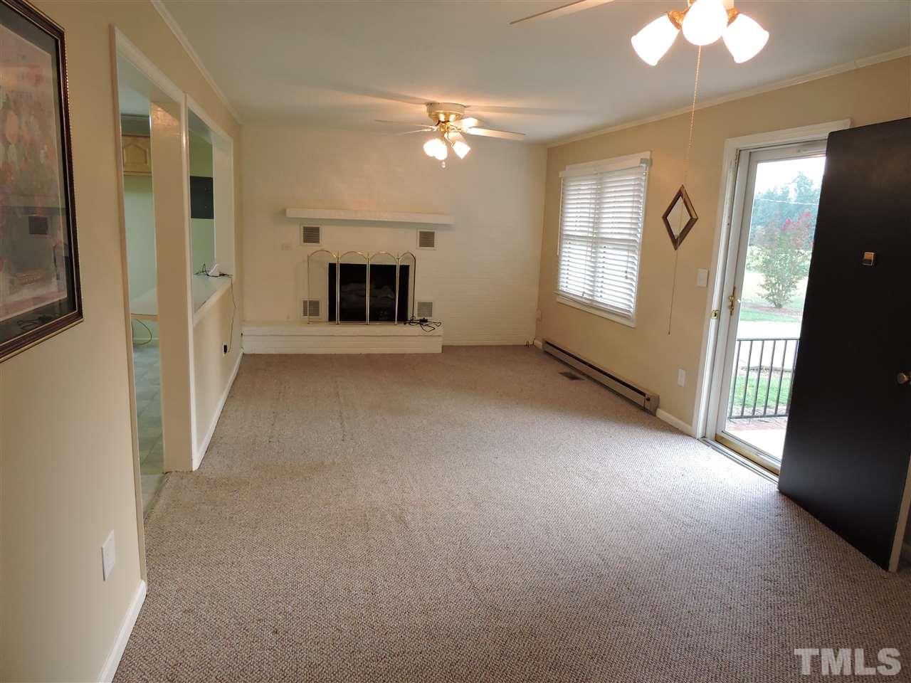 179 Clayton Glenn Road Roxboro, NC 27574 - Photo 2 of 14 an empty room with windows and fireplace