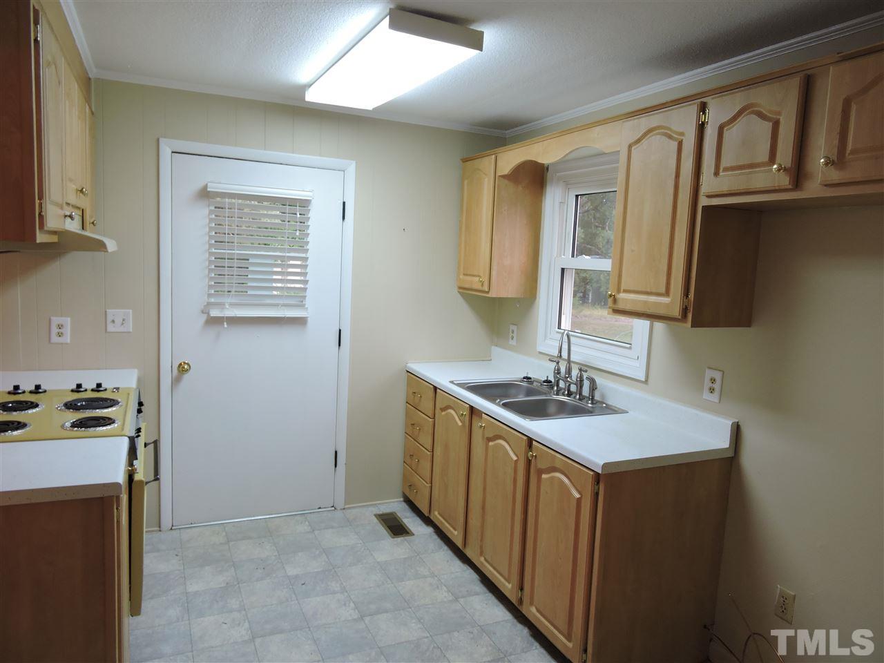 179 Clayton Glenn Road Roxboro, NC 27574 - Photo 5 of 14 a kitchen with stainless steel appliances granite countertop a sink stove and cabinets