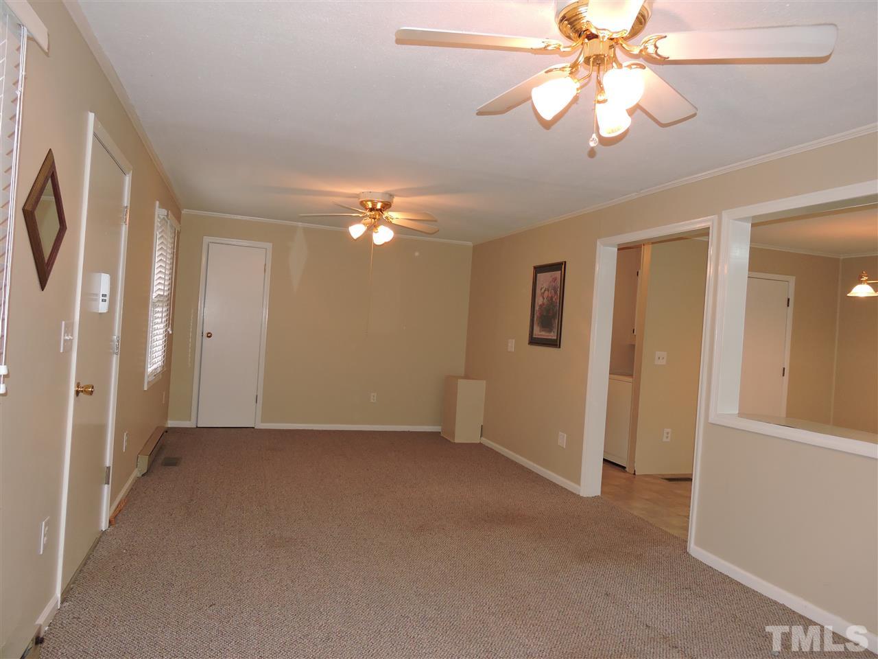 179 Clayton Glenn Road Roxboro, NC 27574 - Photo 8 of 14 wooden floor in an empty room with a window