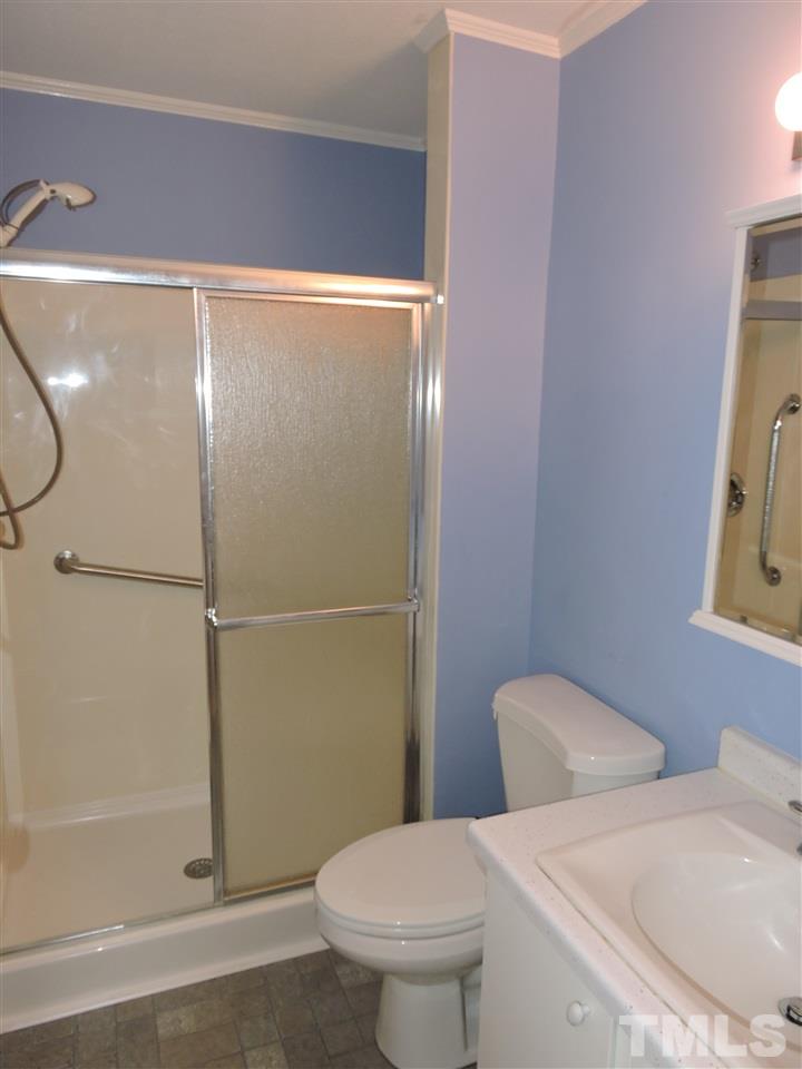 179 Clayton Glenn Road Roxboro, NC 27574 - Photo 9 of 14 a white toilet sitting next to a bathroom sink