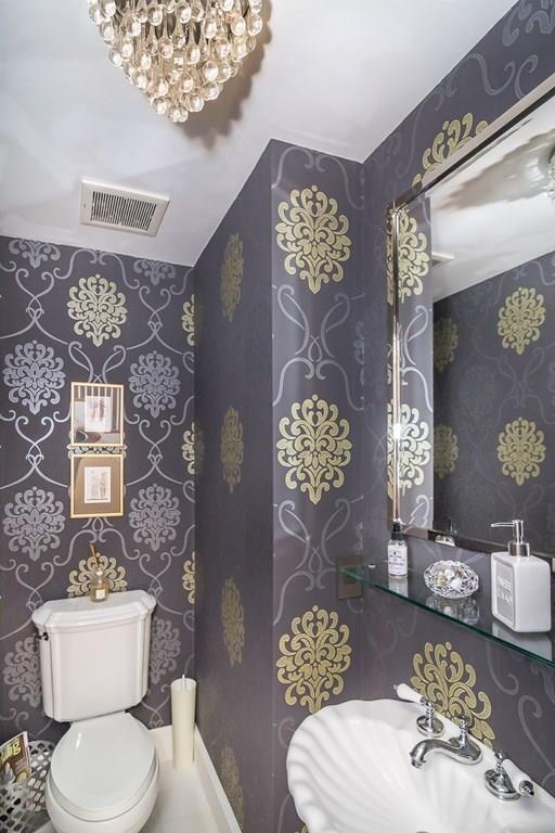 33 Tennyson Road Wellesley, MA 02481 - Photo 15 of 33 a white toilet sitting next to a bathroom sink and a mirror