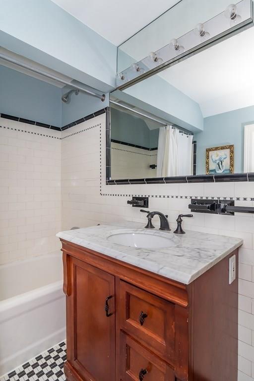 33 Tennyson Road Wellesley, MA 02481 - Photo 23 of 33 a bathroom with a granite countertop sink mirror and a bathtub
