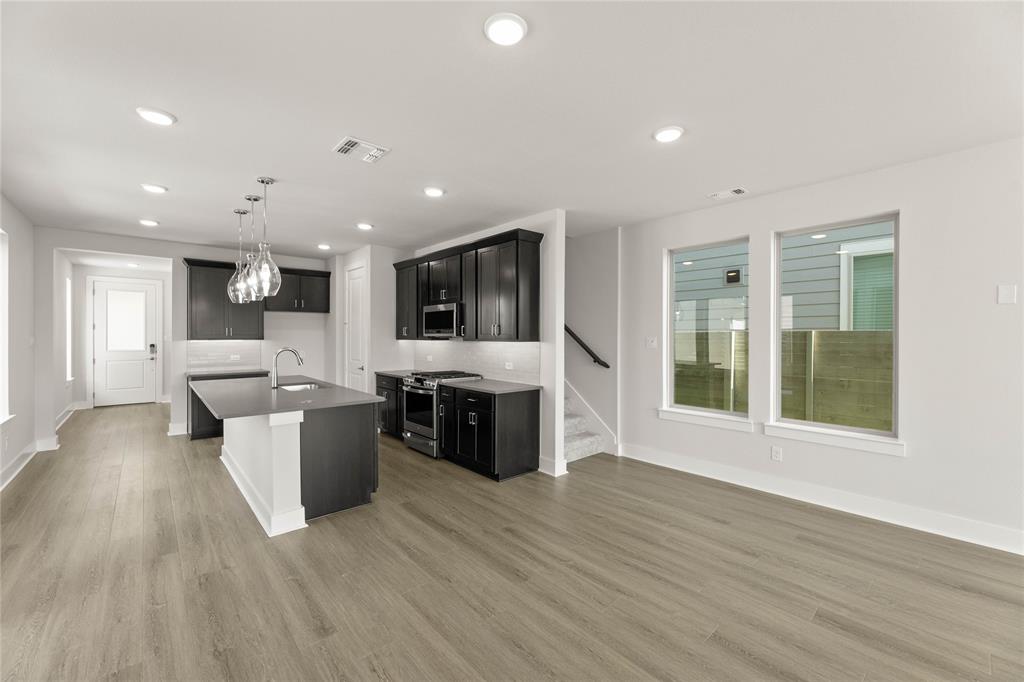 1610 Mint Road Argyle, TX 76226 - Photo 12 of 27 a view of kitchen with stainless steel appliances kitchen island hard wood floors and fireplace