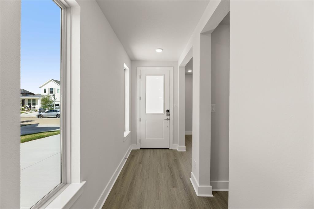 1610 Mint Road Argyle, TX 76226 - Photo 6 of 27 a view of a hallway with wooden floor and a bathroom