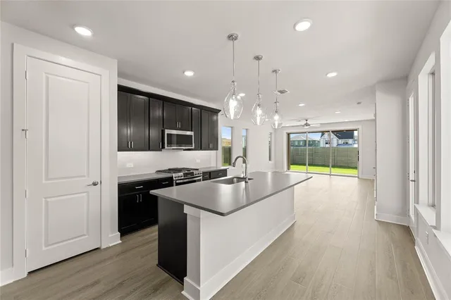 a kitchen with stainless steel appliances granite countertop a stove and a refrigerator