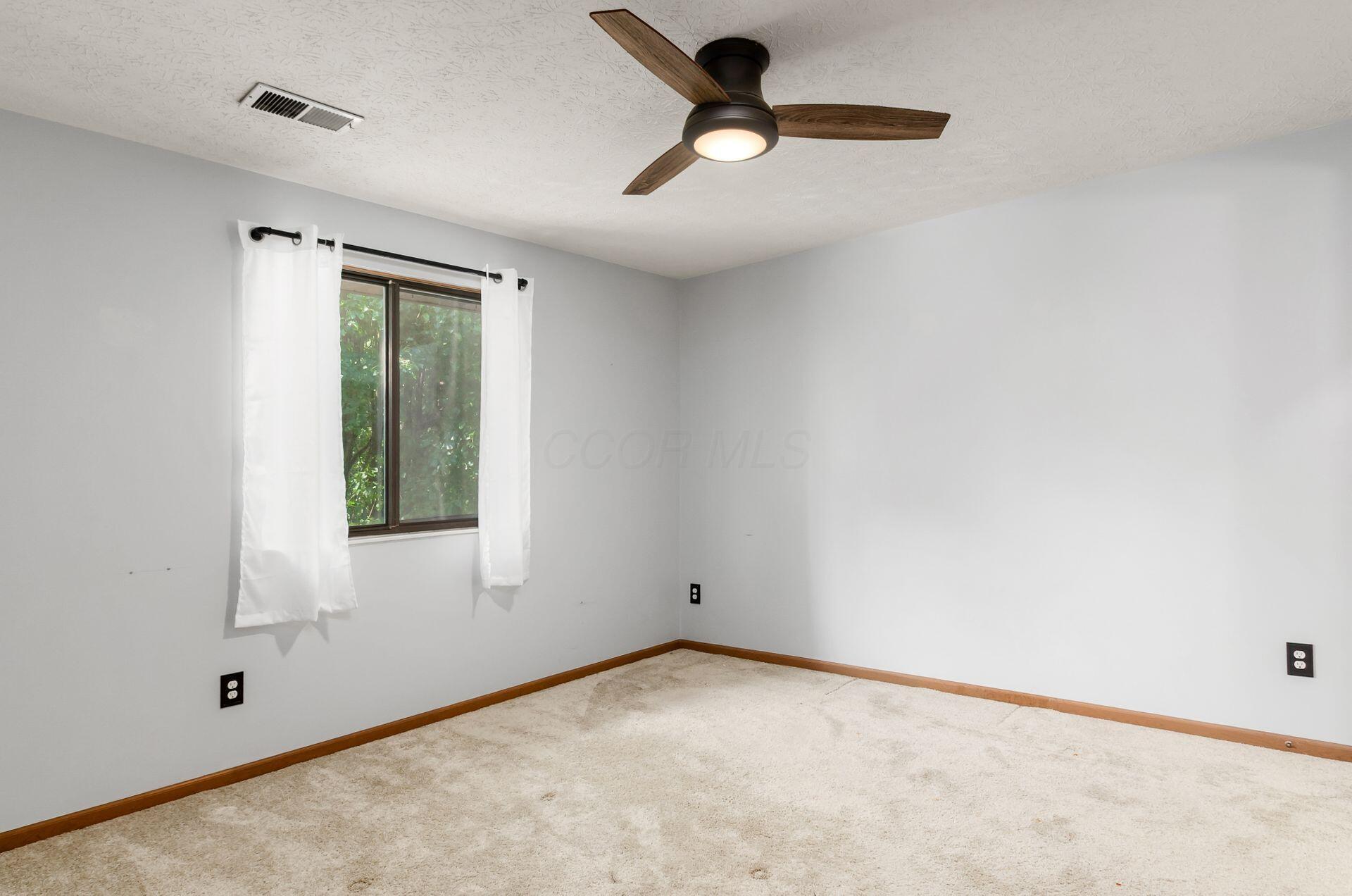 3941 Karl Road, Unit 321 Columbus, OH 43224 - Photo 12 of 26 Large Primary Bedroom with view of the back of the property