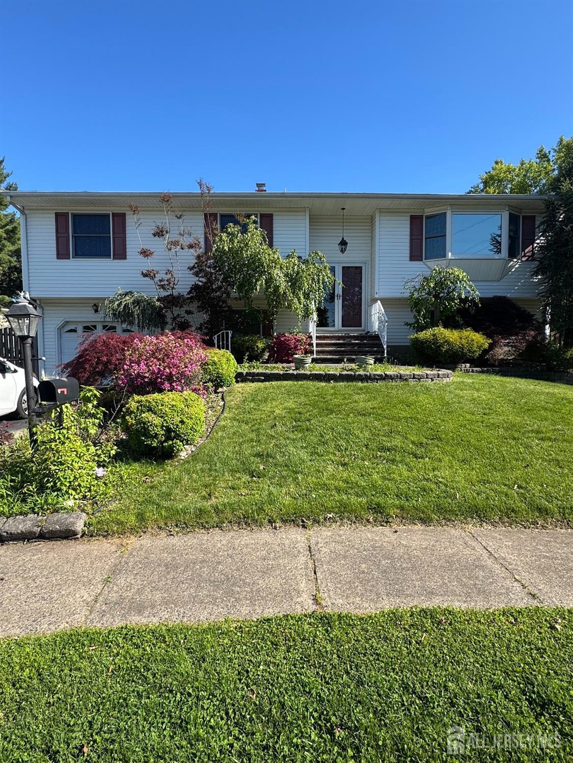 a front view of house with yard and green space