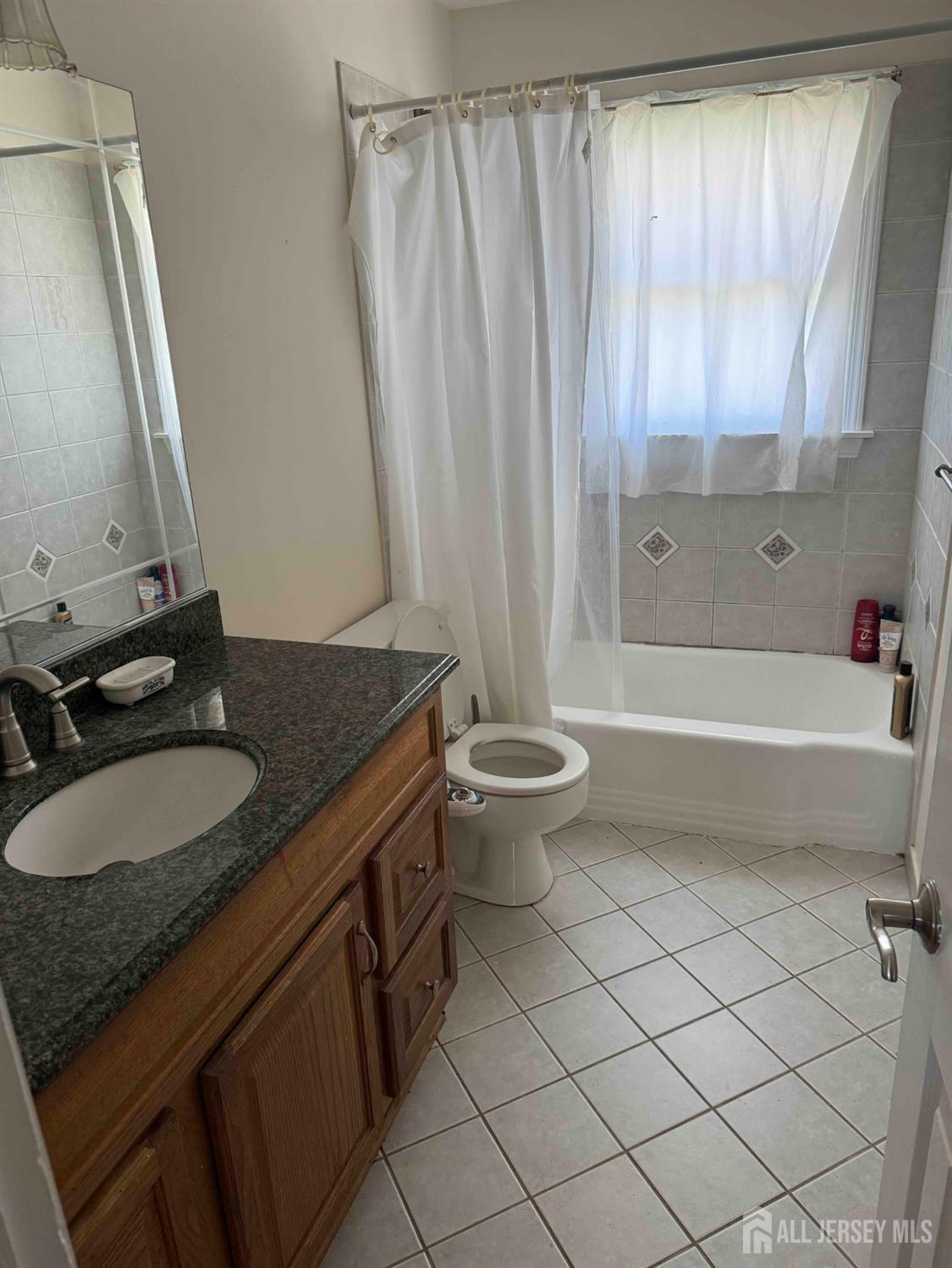 5 Timothy Court Edison, NJ 08837 - Photo 15 of 21 a bathroom with a granite countertop sink and a mirror