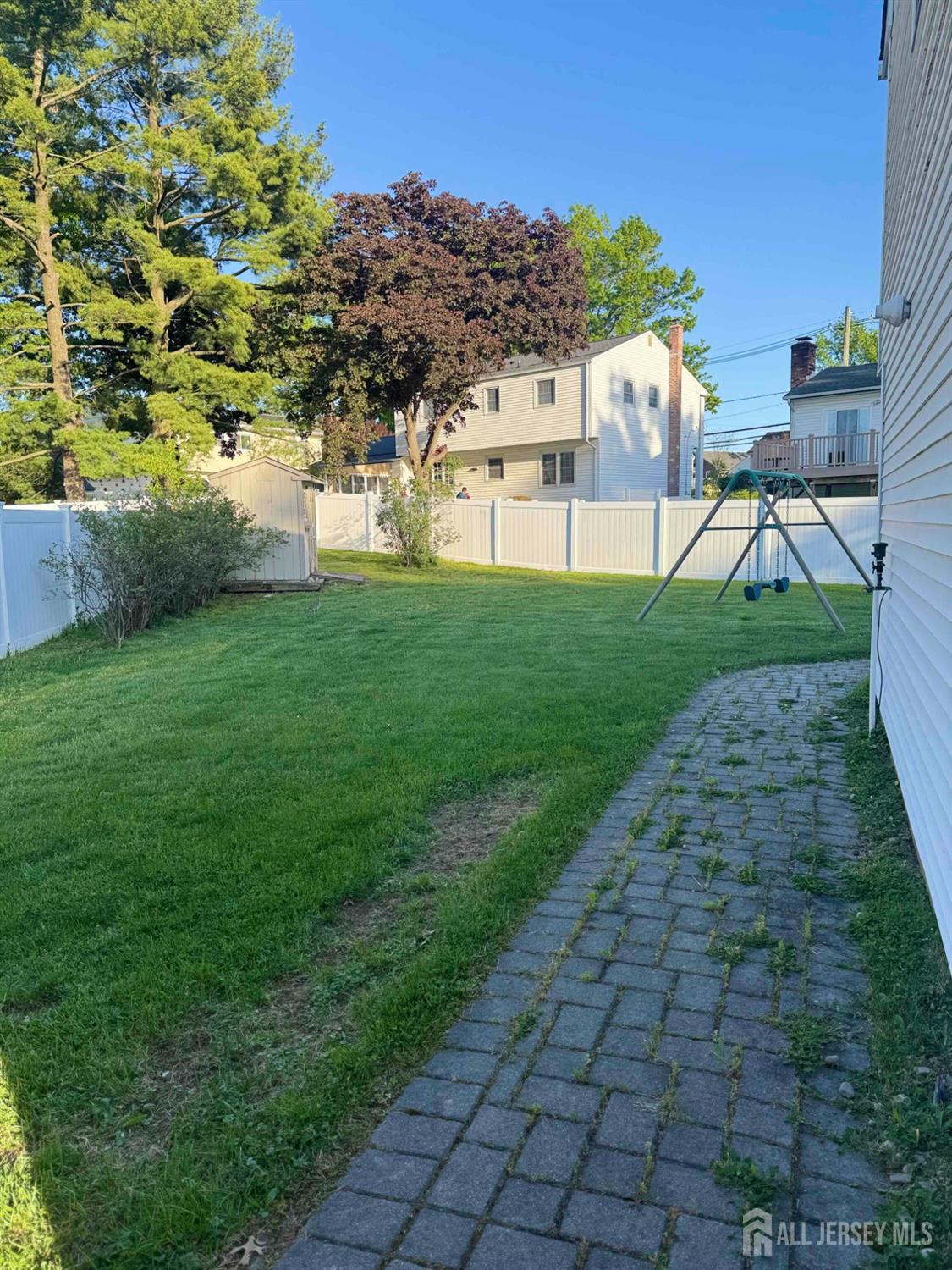 5 Timothy Court Edison, NJ 08837 - Photo 6 of 21 a view of a yard with plants and a bench