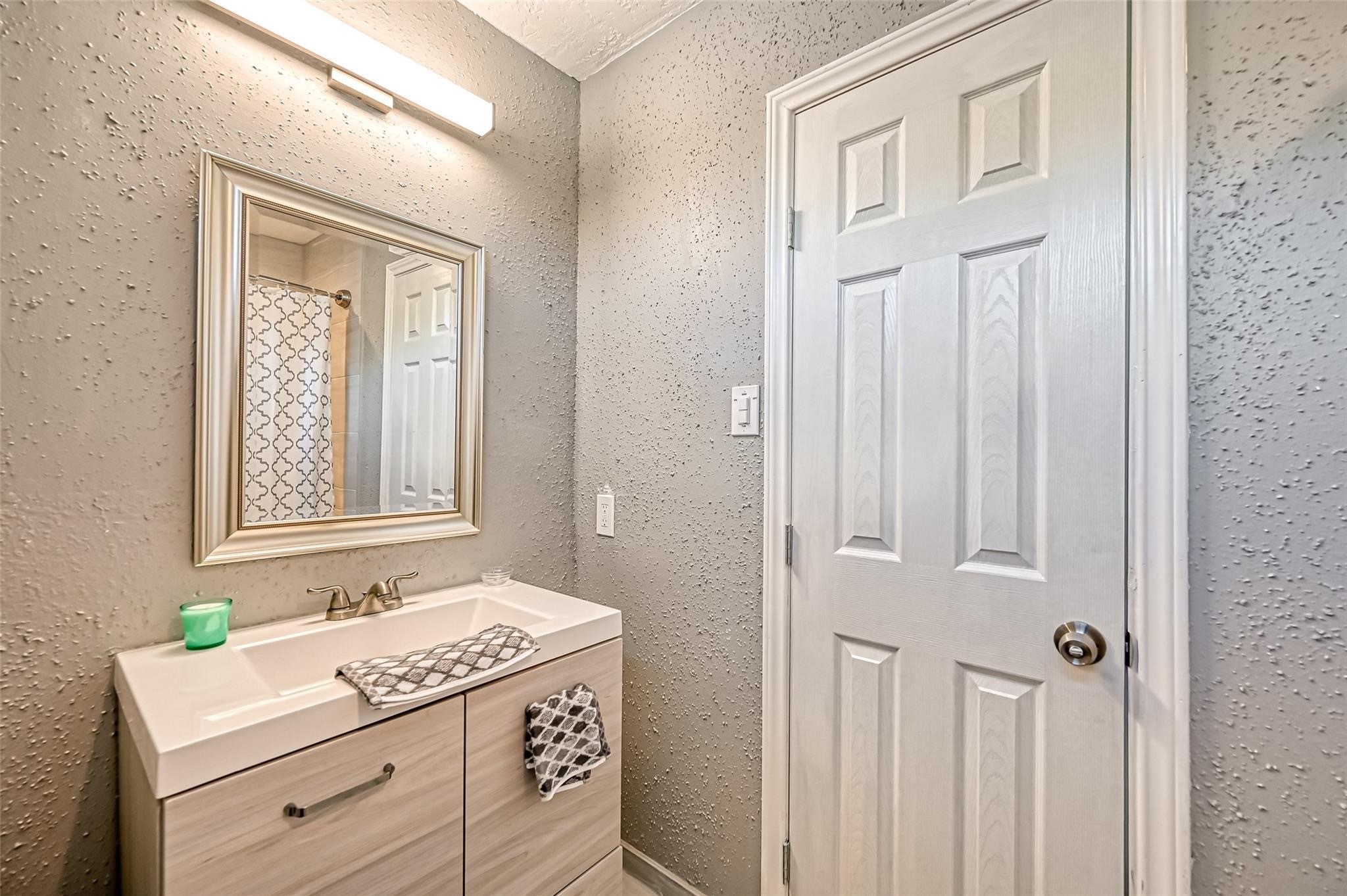 10252 Cottage Field Road Houston, TX 77041 - Photo 5 of 18 a bathroom with a granite countertop sink and a window