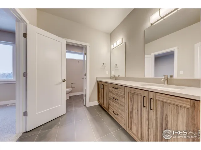 a bathroom with a double vanity sink and mirror