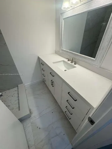 a bathroom with a double vanity sink and mirror