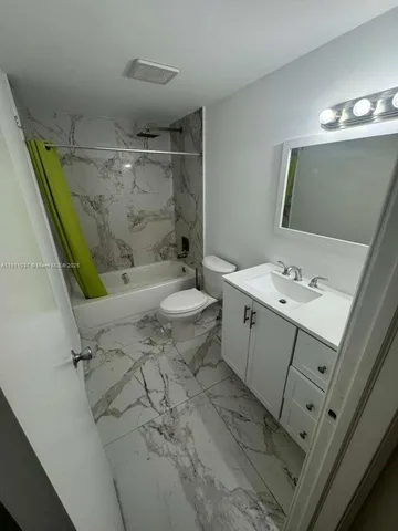 a bathroom with a sink mirror vanity and toilet