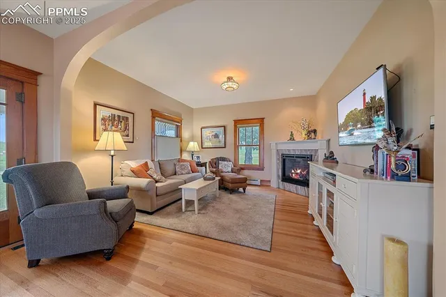 a living room with furniture a flat screen tv and a fireplace