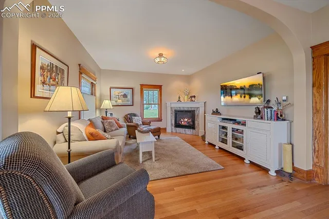 a living room with furniture a flat screen tv and a fireplace