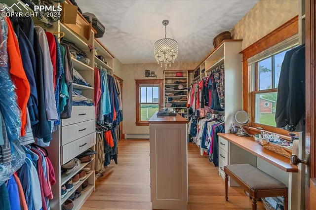 a view of walk in closet with clothes and shoes