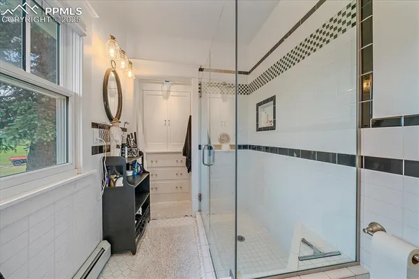 a bathroom with a tub and a shower