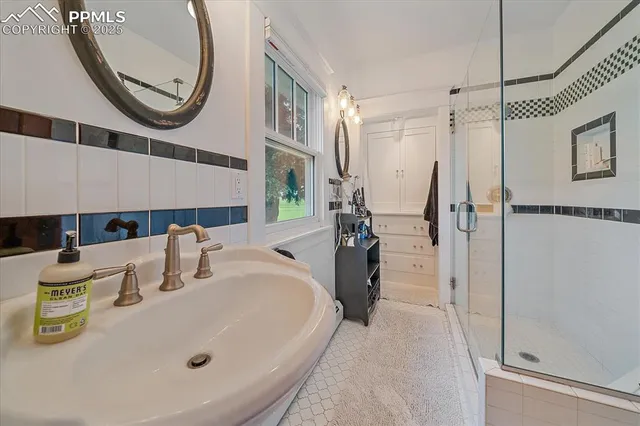 a bath room with a sink and a mirror