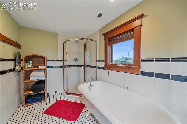 a bathroom with a bathtub and a shower