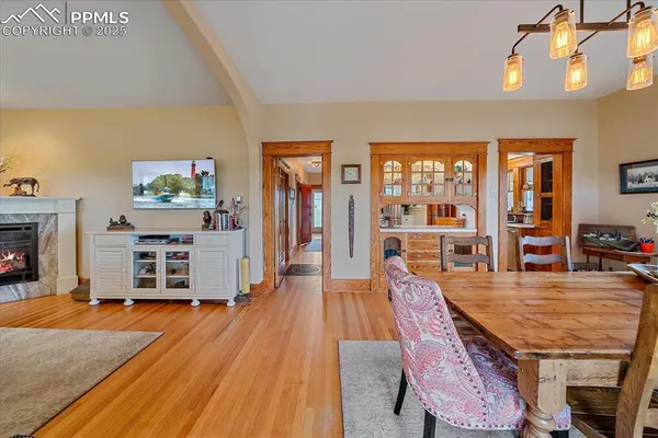a dining room with furniture and wooden floor