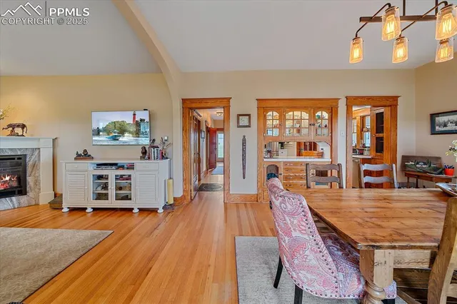 a dining room with furniture and wooden floor