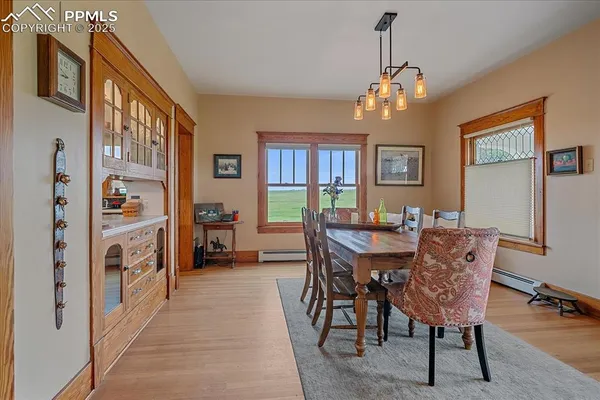a view of a dining room with furniture and a chandelier