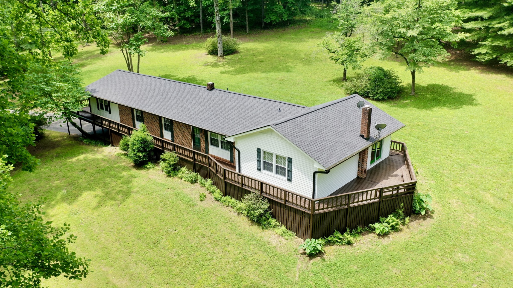 61 Nelson Road Lawrenceburg, TN 38464 - Photo 1 of 55 a aerial view of a house in a big yard with large trees