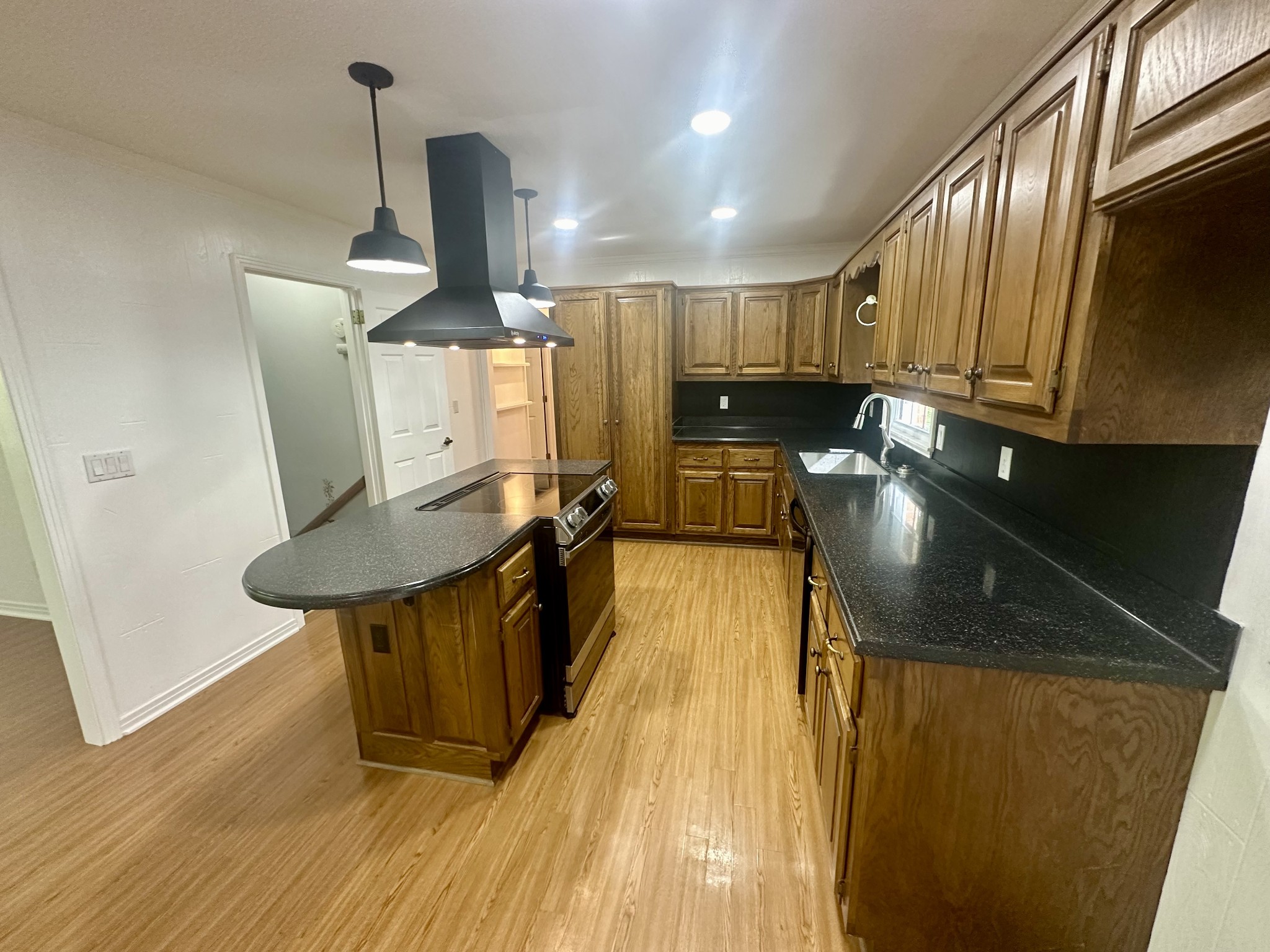 61 Nelson Road Lawrenceburg, TN 38464 - Photo 15 of 55 a kitchen with stainless steel appliances granite countertop sink stove refrigerator and wooden floor