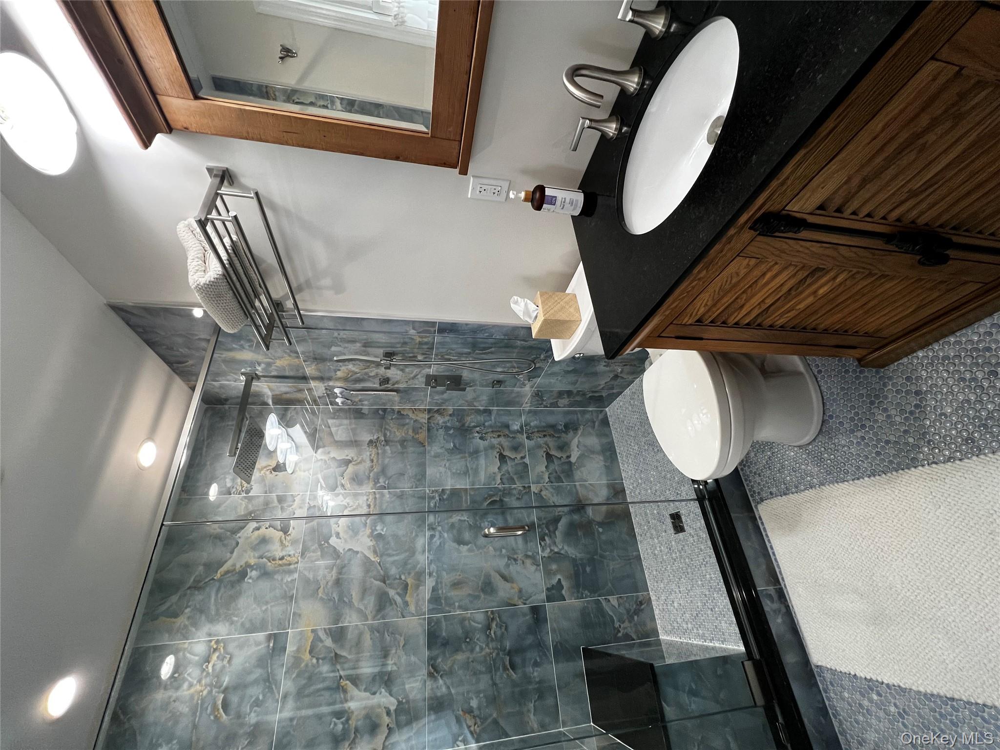 70 South Delrey Road Montauk, NY 11954 - Photo 11 of 22 a bathroom with a granite countertop sink toilet a mirror and shower