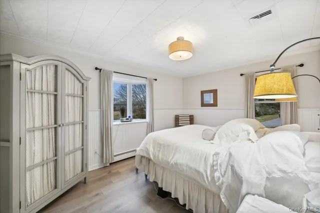 a bedroom with a bed next to a window