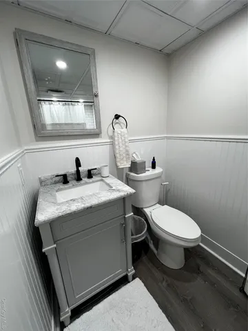 a bathroom with a toilet sink and mirror
