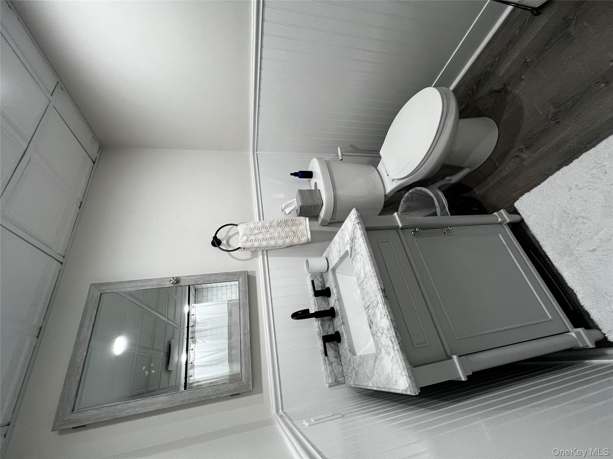 70 South Delrey Road Montauk, NY 11954 - Photo 14 of 22 a bathroom with a toilet sink and mirror