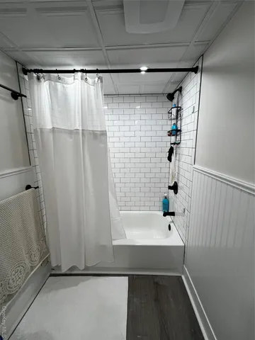 a bathroom with a shower and a tub