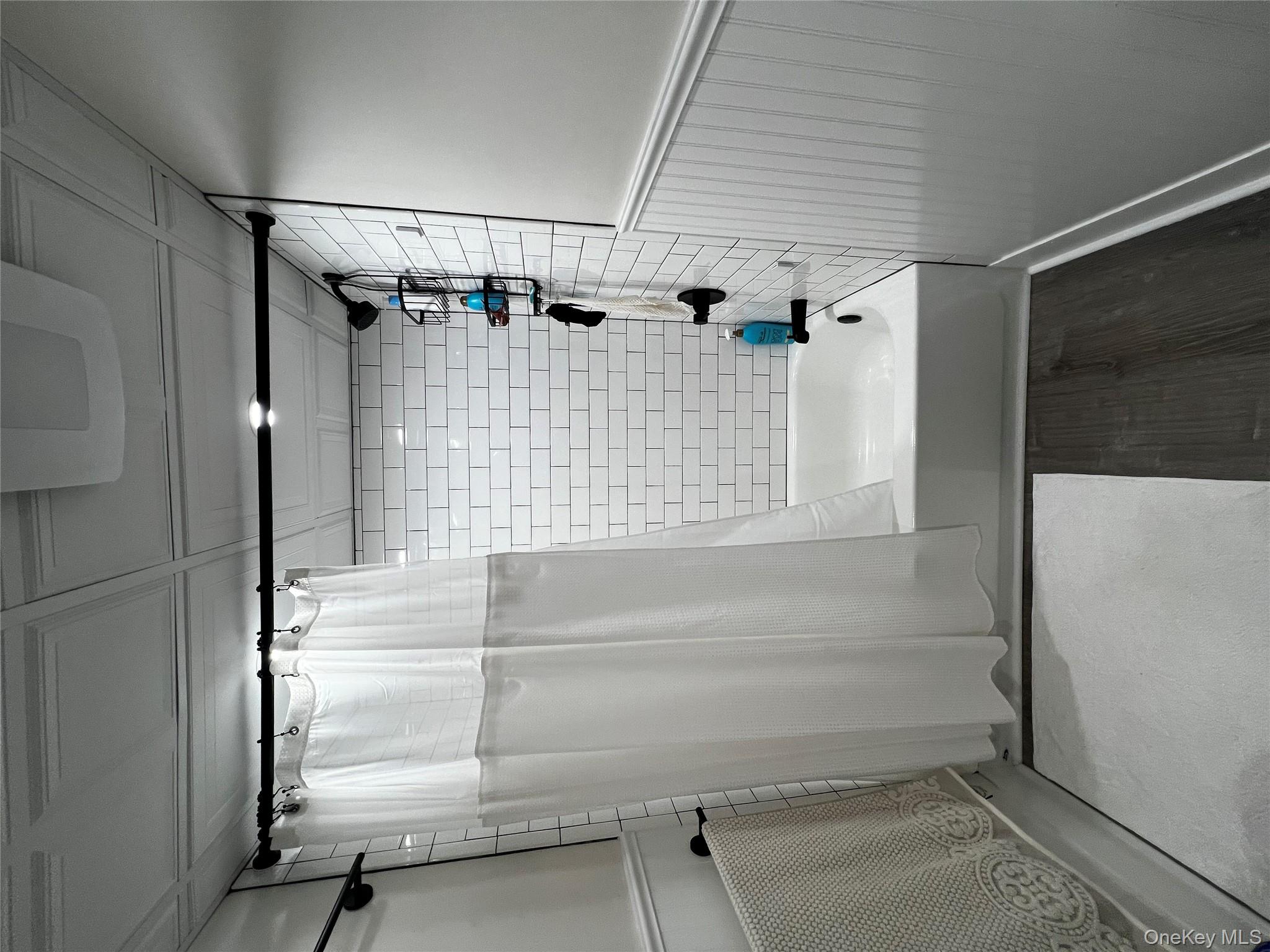 70 South Delrey Road Montauk, NY 11954 - Photo 15 of 22 a bathroom with a shower and a tub