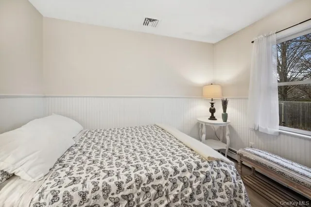 a bedroom with a bed and a large window