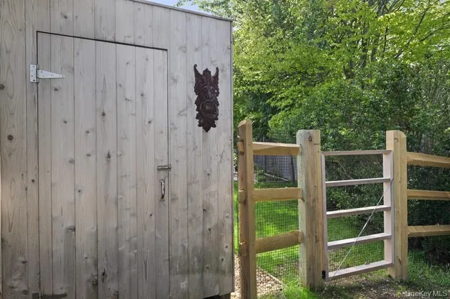 a view of a wooden door and a window