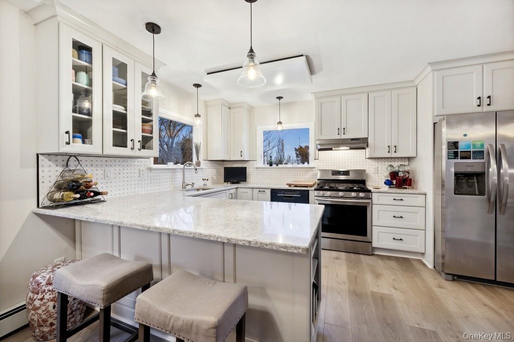 70 South Delrey Road Montauk, NY 11954 - Photo 3 of 22 a kitchen with stainless steel appliances a sink a stove a refrigerator cabinets and chairs