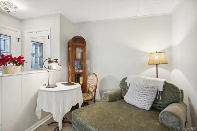 a living room with furniture and a mirror