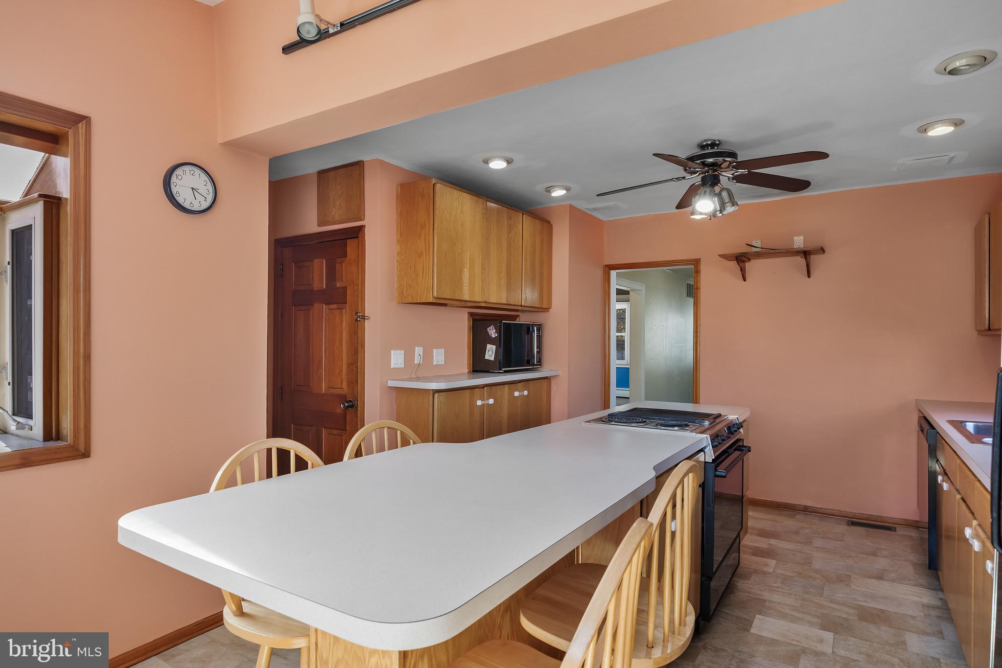 19 South Chestnut Avenue Maple Shade, NJ 08052 - Photo 12 of 31 a kitchen with stainless steel appliances a table chairs and refrigerator