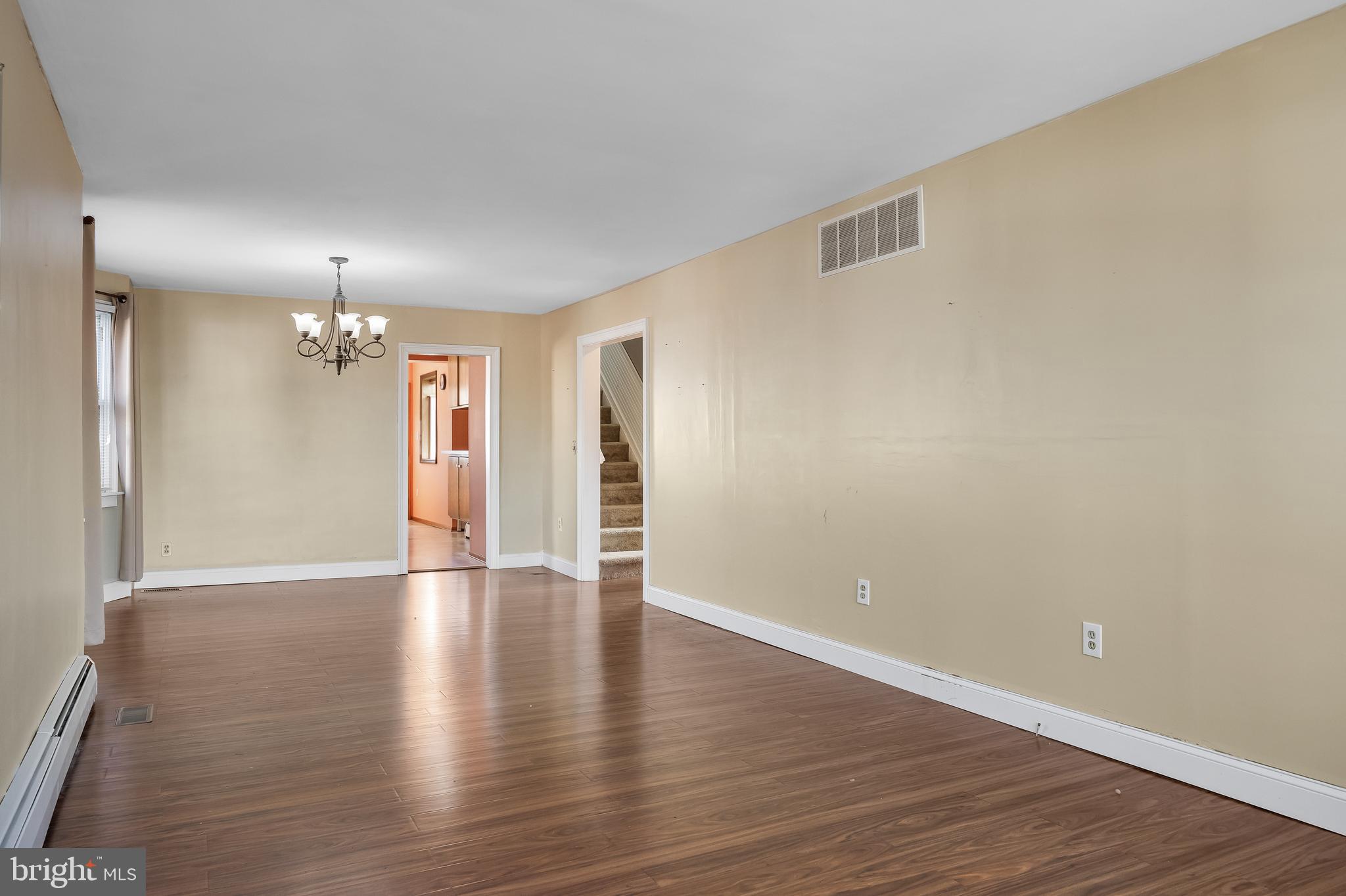 19 South Chestnut Avenue Maple Shade, NJ 08052 - Photo 6 of 31 a view of an empty room with wooden floor kitchen view and a window