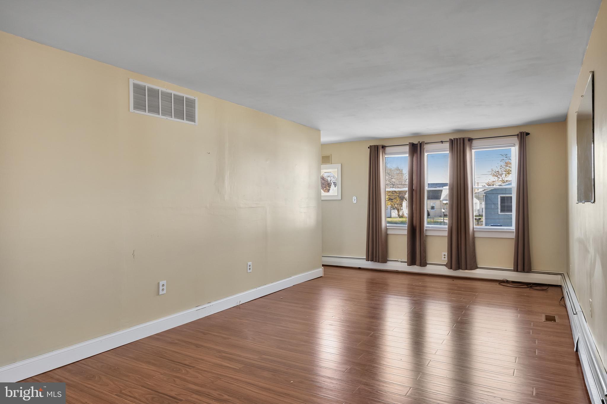 19 South Chestnut Avenue Maple Shade, NJ 08052 - Photo 7 of 31 a view of an empty room with wooden floor and a window
